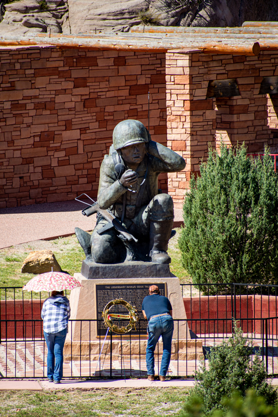 People looking at the Navajo Code Talker statue in the Window Rock Tribal Park and Veterans Memorial Park, in Window Rock, Arizona