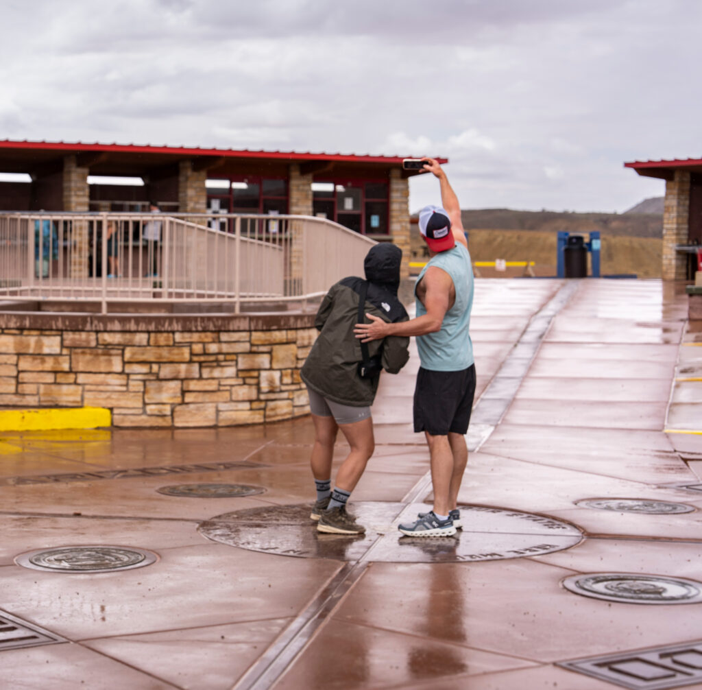 A couple at the Four Corners Monument Navajo Tribal Park taking a selfie.